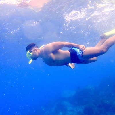 man snorkeling under water