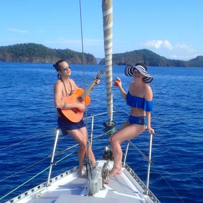 two people with guitar on boat