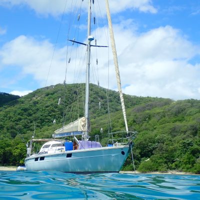 a blue and white boat floating on a body of water