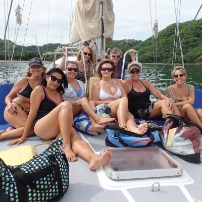 a group of people sitting on a boat posing for the camera