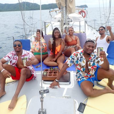 a group of people sitting in a boat on a body of water