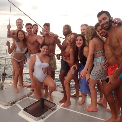 a group of people on a beach posing for the camera