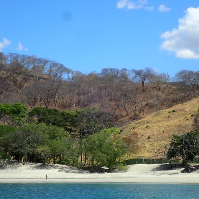 a body of water with a mountain in the background