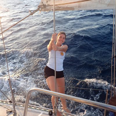 a woman riding on the back of a boat