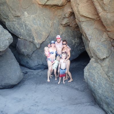 a person standing in front of a large rock