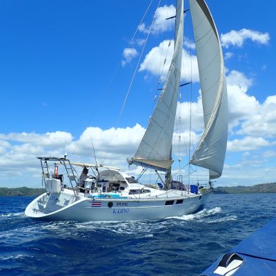 a man in a blue boat on a body of water